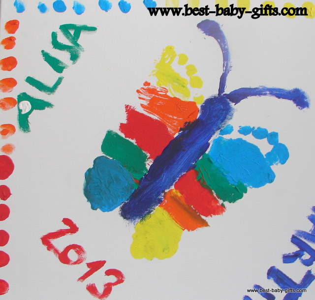 a colorful butterfly on canvas - made out of two baby feet prints, the name Alisa and the year 2013