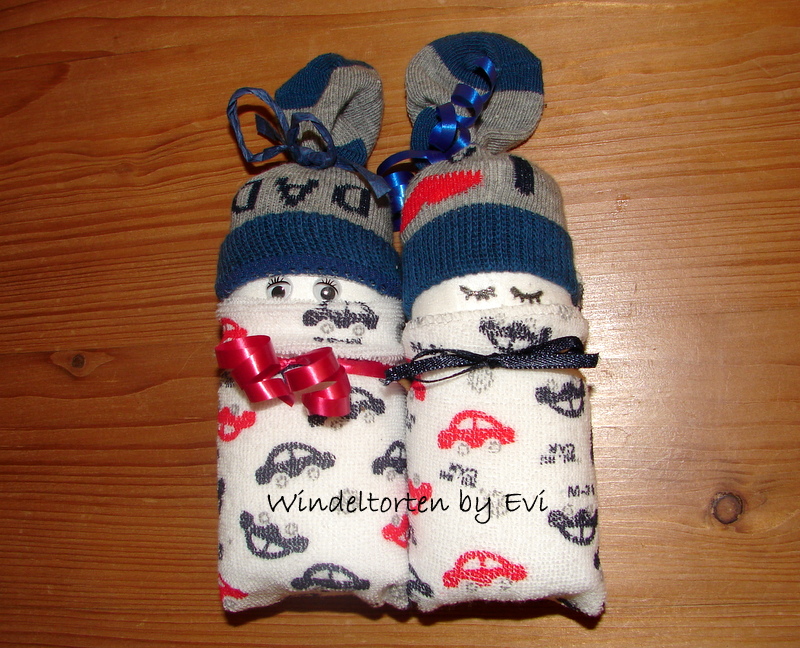 a pair of DIY baby diapers made from 2 diapers, 2 washcloths and a pair of baby socks