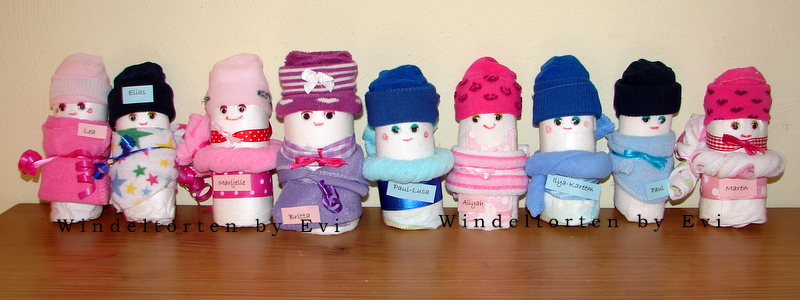 9 diapered babies standing in a row, looking like a swimming pool with bathing suits and bathing caps