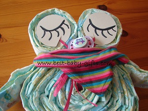 owl with sleeping eyes and baby scarf wrapped around the neck