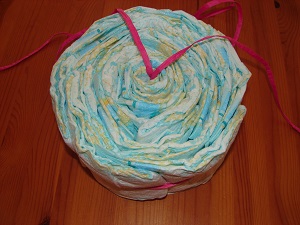 fully filled cake setting ring with diapers from top, ribbon hanging