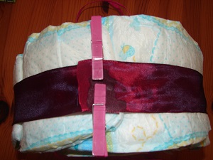 dark red ribbon fixed around the diapers
