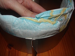 hand putting diapers on ring setting