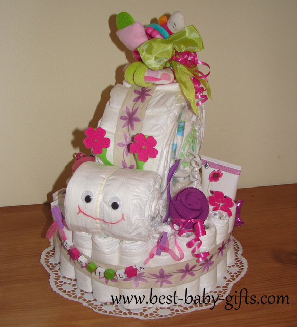 a diaper base with a diaper snail on top in pink and pale green