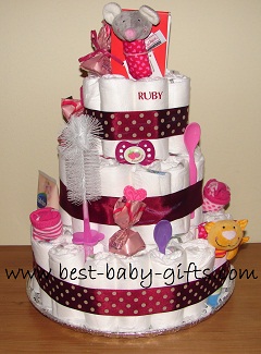 a big girl diaper cake with a plush mouse rattle on top, hot pink