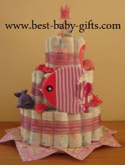 a pink diaper cake featuring a large pink bath sponge and squirting baby girl toys
