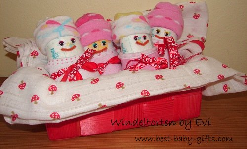 4 fun baby girl diapers in a little red basket