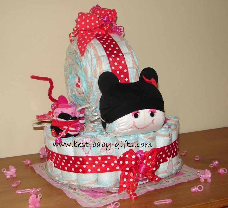 a diaper base and a Minnie Mouse diaper snail on top, red polka dots ribbon