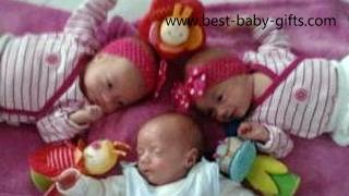 newborn triplets laying on their backs the floor, two girls and a boy